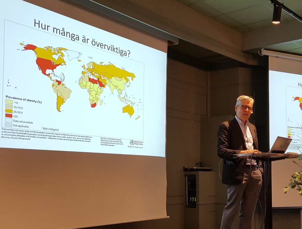 Johan Ottosson står på en scen och föreläser om Skandinaviska Obesitasregistret.